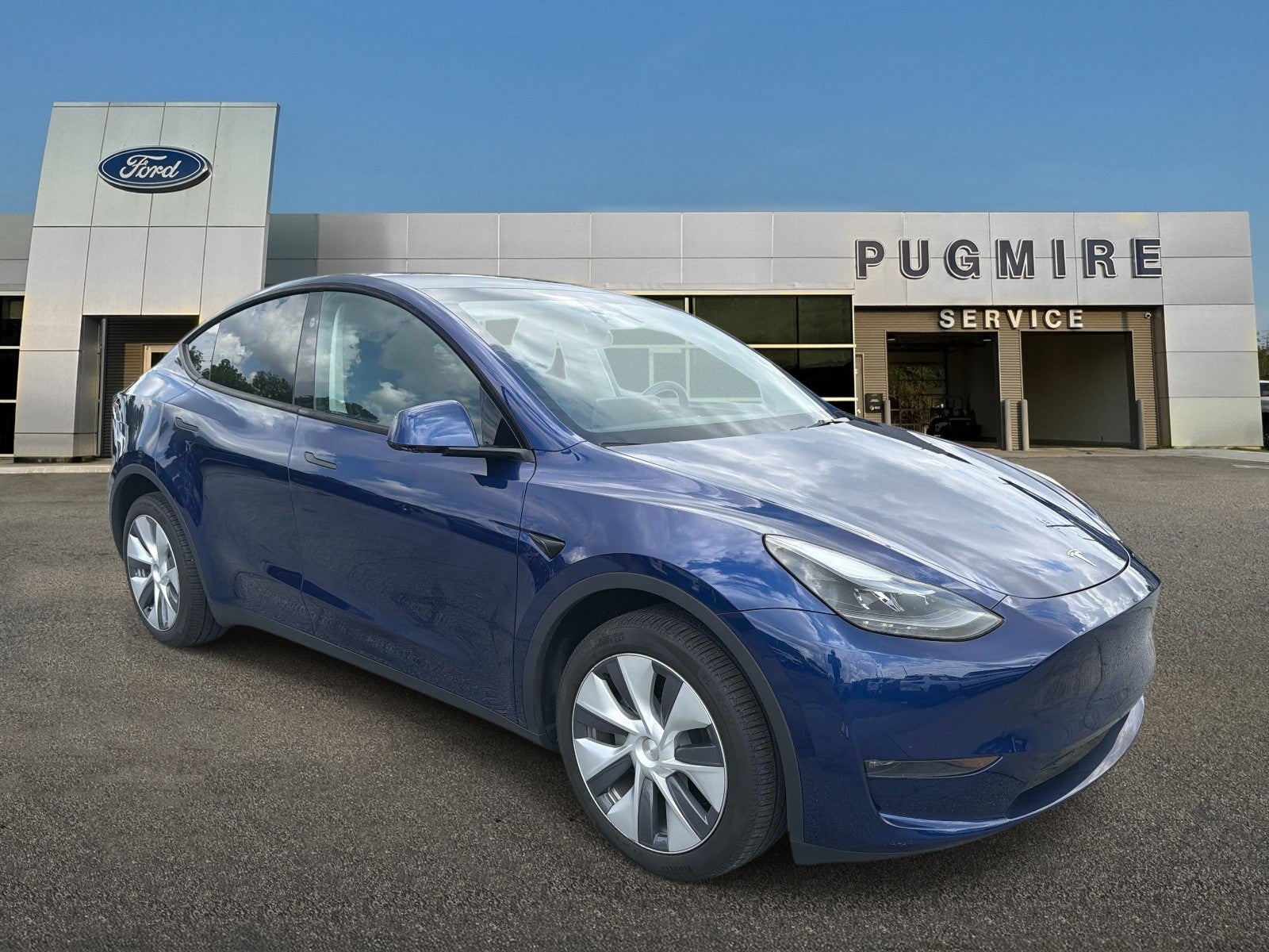 2024 Tesla Model Y Long Range in Deep Blue Metallic Blue — front three-quarter view